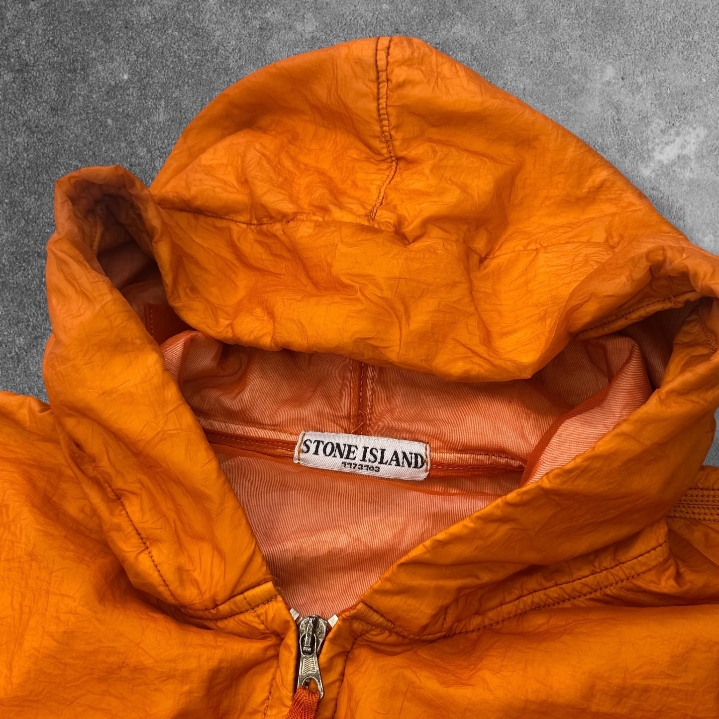 Stone Island SS 2008 Superlight Resined Nylon Hooded Jacket, Drawstring hood. Full zip fastening with storm flap. Two diagonal front pockets with hidden snap fastening. Elasticated cuffs and hem. Mesh badge. Orange, xxl but fits xl to

ART. 48154833/1453