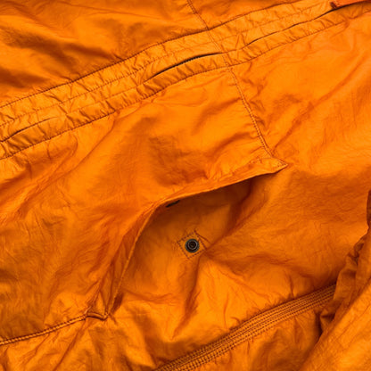 Stone Island SS 2008 Superlight Resined Nylon Hooded Jacket, Drawstring hood. Full zip fastening with storm flap. Two diagonal front pockets with hidden snap fastening. Elasticated cuffs and hem. Mesh badge. Orange, xxl but fits xl to

ART. 48154833/1453