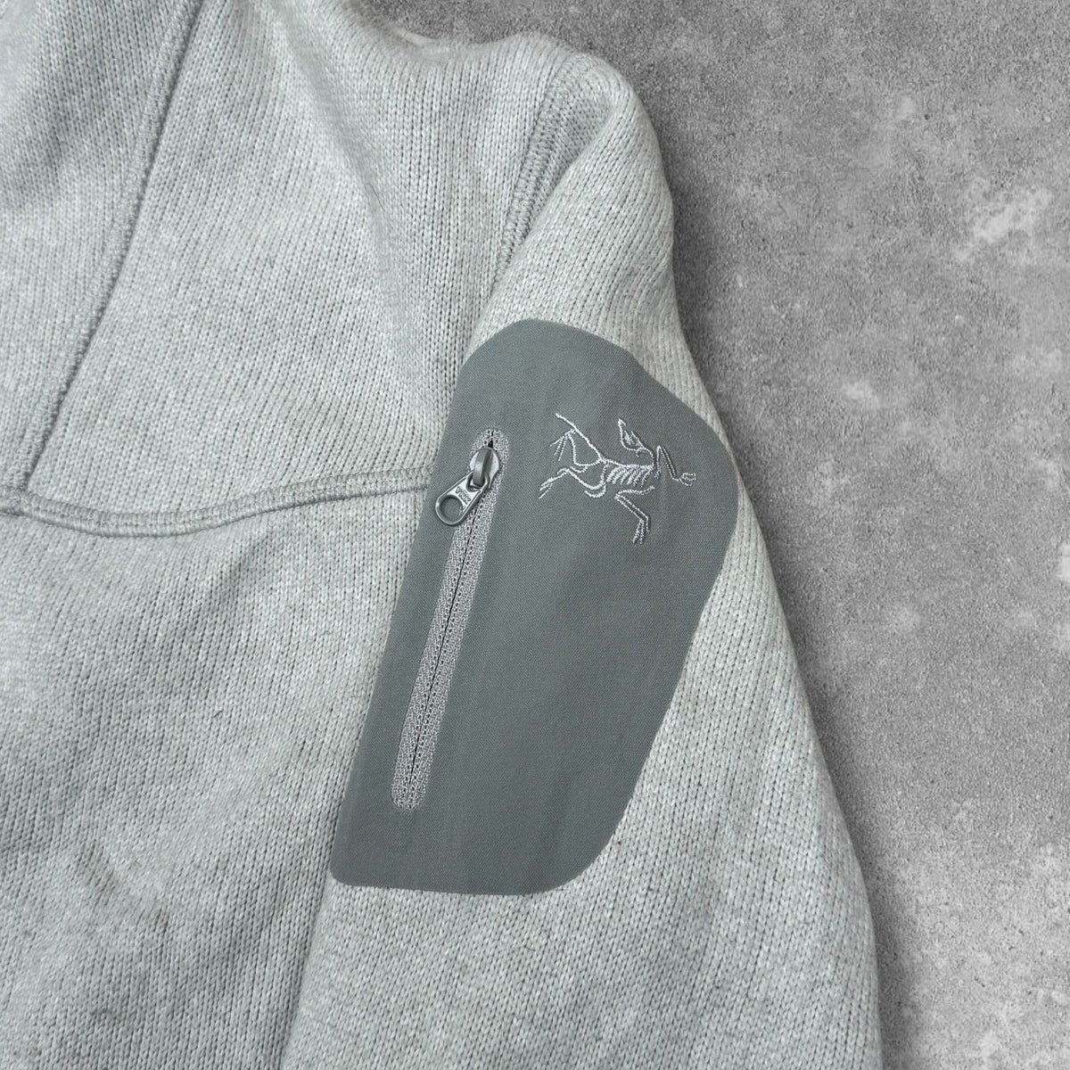 Covert Cardigan sleeve pocket and logo